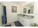 Bright bathroom with a large mirror, double sinks, shower, and granite countertop at 1313 Middle Lake Dr, Ormond Beach, FL 32174