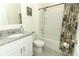 Bathroom featuring granite countertop, white cabinets, and a shower-tub combination at 1313 Middle Lake Dr, Ormond Beach, FL 32174