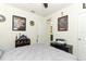 A bedroom featuring fan decorations, a printer, and a comfortable-looking bed at 1313 Middle Lake Dr, Ormond Beach, FL 32174
