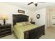 Cozy bedroom with bed, lamps, and ceiling fan. Decorated in neutral colors at 1313 Middle Lake Dr, Ormond Beach, FL 32174