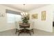Cozy dining area with neutral colors, bright window, and modern chandelier at 1313 Middle Lake Dr, Ormond Beach, FL 32174