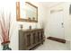 Inviting entryway with decorative cabinet and large mirror creates a warm and welcoming first impression at 1313 Middle Lake Dr, Ormond Beach, FL 32174
