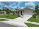 Inviting exterior showcasing a well-manicured lawn, beautiful landscaping, and a two-car garage, creating an appealing curb appeal at 1313 Middle Lake Dr, Ormond Beach, FL 32174
