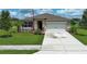 Beautiful single-Gathering home featuring a well manicured lawn and a two-car garage at 1313 Middle Lake Dr, Ormond Beach, FL 32174