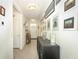 Bright hallway featuring art and decorative touches leading to a white front door at 1313 Middle Lake Dr, Ormond Beach, FL 32174