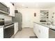 Stylish kitchen featuring stainless steel appliances, granite countertops, and ample storage space at 1313 Middle Lake Dr, Ormond Beach, FL 32174