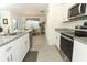 Well-equipped kitchen with stainless steel appliances, granite countertops, and access to the dining area at 1313 Middle Lake Dr, Ormond Beach, FL 32174