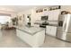 Bright kitchen boasts stainless steel appliances, granite countertops, and a center island for cooking and entertaining at 1313 Middle Lake Dr, Ormond Beach, FL 32174