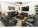Spacious living room featuring recliners and leather sofas with an elegant rug and wooden coffee table at 1313 Middle Lake Dr, Ormond Beach, FL 32174