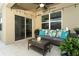 Covered patio area with wicker furniture, bright pillows, and string lights overhead at 1313 Middle Lake Dr, Ormond Beach, FL 32174