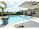 Backyard pool with outdoor seating, decorative fountains, and serene views at 1313 Middle Lake Dr, Ormond Beach, FL 32174
