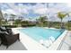 Backyard oasis with a modern pool, swan floaties and elegant lounge seating at 1313 Middle Lake Dr, Ormond Beach, FL 32174