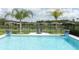 Private pool overlooking a serene pond, with comfortable lounge chairs for relaxation at 1313 Middle Lake Dr, Ormond Beach, FL 32174