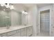 Modern bathroom featuring dual sinks, quartz countertops, and a walk-in shower at 13562 Pearl Beach St, Winter Garden, FL 34787
