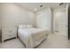 Neutral bedroom featuring marble floors, a white bed, and a closet with ample storage space at 13562 Pearl Beach St, Winter Garden, FL 34787