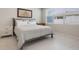 Bright bedroom featuring neutral walls, marble floors, a large window, and contemporary furniture at 13562 Pearl Beach St, Winter Garden, FL 34787