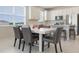 Dining area featuring a modern table, leather chairs, stainless steel appliances and bright lighting at 13562 Pearl Beach St, Winter Garden, FL 34787