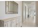 Hallway featuring neutral paint, white trim, and a rustic accent table at 13562 Pearl Beach St, Winter Garden, FL 34787