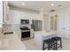 Bright kitchen with stainless steel appliances, white cabinetry, quartz countertops, and eat-in island at 13562 Pearl Beach St, Winter Garden, FL 34787