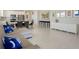 Open-concept living room with white walls, marble floors, comfortable sofa, and view of the kitchen at 13562 Pearl Beach St, Winter Garden, FL 34787