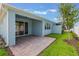 Back patio with brick ground cover and blue siding at 13562 Pearl Beach St, Winter Garden, FL 34787