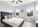 Bedroom with two windows, a large mirror, and a modern black headboard at 14126 Walcott Ave, Orlando, FL 32827