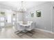 Modern dining area with sleek table and chairs, complemented by a stylish chandelier at 14126 Walcott Ave, Orlando, FL 32827