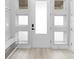 Well-lit entryway featuring sidelight windows and a convenient bench at 14126 Walcott Ave, Orlando, FL 32827