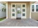 Close-up of the front door with adjacent sidelight windows at 14126 Walcott Ave, Orlando, FL 32827