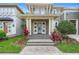 Inviting two-story home with a decorative door and landscaping, offering curb appeal and a welcoming entrance at 14126 Walcott Ave, Orlando, FL 32827