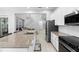 Modern kitchen with stainless steel appliances, white cabinets, and island with sink in an open concept layout at 14126 Walcott Ave, Orlando, FL 32827