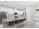 Modern kitchen with white cabinets, stainless steel appliances, a central island, and breakfast bar seating at 14126 Walcott Ave, Orlando, FL 32827