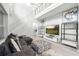Spacious living room featuring a modern staircase, sleek decor, high ceilings, and abundant natural light at 14126 Walcott Ave, Orlando, FL 32827