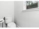 Clean and simple powder room with a modern toilet and window at 14126 Walcott Ave, Orlando, FL 32827