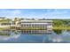 Beautiful waterfront restaurant, with a large sign on top reflected in the water at 14126 Walcott Ave, Orlando, FL 32827
