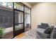 Comfortable sitting area with round chair and decorative pillows opens to landscaped outdoor patio at 14126 Walcott Ave, Orlando, FL 32827