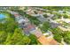 Aerial view of a quiet residential neighborhood featuring lush landscaping and a community pond at 14312 Paradise Tree Dr, Orlando, FL 32828
