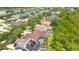 Aerial view of a residential neighborhood featuring mature landscaping and a community lake at 14312 Paradise Tree Dr, Orlando, FL 32828