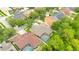 Aerial view of a house and neighborhood with a screened in pool and lush landscaping at 14312 Paradise Tree Dr, Orlando, FL 32828