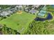 Aerial view of baseball field, tennis courts and pond in community at 14312 Paradise Tree Dr, Orlando, FL 32828