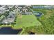 Aerial view of baseball field, tennis courts and pond in community at 14312 Paradise Tree Dr, Orlando, FL 32828