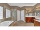 Beautiful primary bathroom with dual vanity sinks, bathtub, and glass shower at 14312 Paradise Tree Dr, Orlando, FL 32828