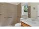 Well lit bathroom offers a tile shower with grab bars and single sink vanity at 14312 Paradise Tree Dr, Orlando, FL 32828