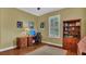 Bedroom featuring neutral walls, hardwood floors, shutters, a ceiling fan, and a desk at 14312 Paradise Tree Dr, Orlando, FL 32828
