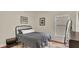 Well lit bedroom features a patterned rug, queen bed, and window view at 14312 Paradise Tree Dr, Orlando, FL 32828