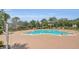 Inviting community pool surrounded by ample lounge chairs, providing a perfect space for relaxation at 14312 Paradise Tree Dr, Orlando, FL 32828