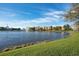 Scenic view of a waterfront community with lush green spaces, a fountain, and elegant architecture at 14312 Paradise Tree Dr, Orlando, FL 32828