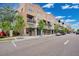 Commercial buildings featuring storefronts and upper-level balconies along a city street at 14312 Paradise Tree Dr, Orlando, FL 32828