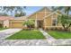 Charming single-Gathering home with a well-manicured lawn, beautiful landscaping, and a two-car garage at 14312 Paradise Tree Dr, Orlando, FL 32828