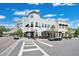 Community exterior featuring attractive clock tower, street-side parking, and pedestrian crosswalk at 14312 Paradise Tree Dr, Orlando, FL 32828